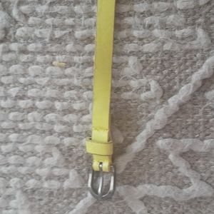 Yellow Slim belt Never Worn 39" in length and 1/2 Wide.Silver buckle.